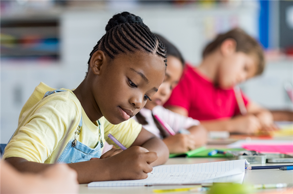 Girl writing in Class Girl writing in Class