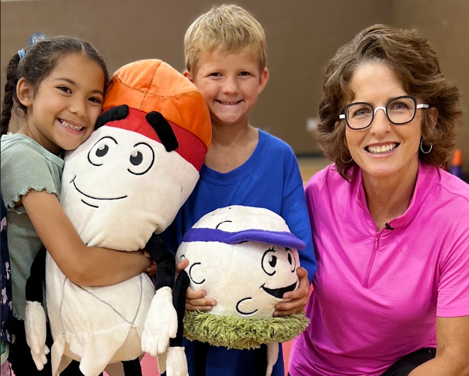  Local author Dr. Beth Brown and first grade students at Prairie Queen Elementary School.