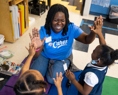  Volunteer giving students a high-five